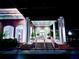 Elegant clubhouse entrance with columns and landscaping at night at 6501 Stone River Rd # 203, Bradenton, FL 34203