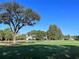 Aerial view of a tranquil community with lush landscaping and homes near a golf course at 6501 Stone River Rd # 203, Bradenton, FL 34203