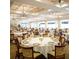 Large dining room with many tables and chairs, ready for events at 6501 Stone River Rd # 203, Bradenton, FL 34203