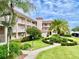 Exterior view of building with landscaping at 6501 Stone River Rd # 203, Bradenton, FL 34203
