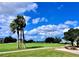 Expansive golf course with palm trees and a cart path at 6501 Stone River Rd # 203, Bradenton, FL 34203