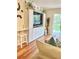 Living room showcasing built-in entertainment center and hardwood floors at 6501 Stone River Rd # 203, Bradenton, FL 34203