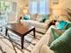 Living room with beige sofa and coffee table at 6501 Stone River Rd # 203, Bradenton, FL 34203