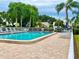 Community pool with lounge chairs and patio area at 6501 Stone River Rd # 203, Bradenton, FL 34203