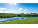 Serene view of a canal reflecting the blue sky and fluffy clouds at 6838 67Th Street E Cir, Palmetto, FL 34221