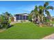 Single-story home with a landscaped lawn and tropical plants at 8524 Imperial Cir # 8524, Palmetto, FL 34221