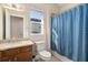 Bathroom features a vanity with a marble countertop and a blue patterned shower curtain at 942 Preservation St, Bradenton, FL 34208
