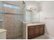 A bathroom featuring a glass shower and a wooden vanity with a stone countertop at 942 Preservation St, Bradenton, FL 34208