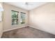Clean, carpeted bedroom with neutral walls and two large windows offering ample natural light at 942 Preservation St, Bradenton, FL 34208