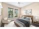 Bedroom with decor, bed with neutral comforter, and two windows for natural light at 942 Preservation St, Bradenton, FL 34208