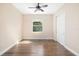Cozy bedroom featuring a ceiling fan, closet, and hardwood floors, offering a serene retreat at 942 Preservation St, Bradenton, FL 34208