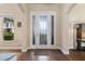 Inviting foyer featuring a glass front door, transom window, and hardwood floors at 942 Preservation St, Bradenton, FL 34208