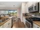 Kitchen featuring stainless steel appliances, granite countertops, and dark hardwood floors at 942 Preservation St, Bradenton, FL 34208