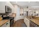 Kitchen featuring granite countertops, stainless steel appliances, and white cabinetry at 942 Preservation St, Bradenton, FL 34208