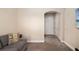 A living room that includes a sofa with a pillow, an open archway, and two doors at 942 Preservation St, Bradenton, FL 34208