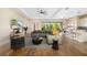 Bright living room with hardwood floors, comfortable seating, and access to a backyard view at 942 Preservation St, Bradenton, FL 34208