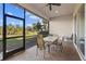 Screened-in patio featuring brick flooring and outdoor seating overlooking the lush backyard at 942 Preservation St, Bradenton, FL 34208