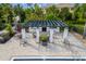 Outdoor pool area featuring a gazebo, outdoor kitchen, fireplace, and seating area at 942 Preservation St, Bradenton, FL 34208