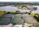 Aerial view featuring well-maintained community tennis courts and landscaping at 942 Preservation St, Bradenton, FL 34208