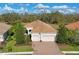 Single-story home with tile roof, two-car garage, and landscaped yard at 963 River Wind Cir, Bradenton, FL 34212