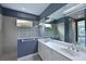 Modern bathroom with dual sinks, a glass-enclosed shower, and sleek fixtures at 963 River Wind Cir, Bradenton, FL 34212