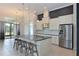 Modern open concept kitchen with stainless steel appliances and eat-in island at 963 River Wind Cir, Bradenton, FL 34212