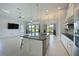 Modern open concept kitchen, dining, and living area with large windows and lots of natural light at 963 River Wind Cir, Bradenton, FL 34212