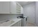 Bright laundry room with washer, dryer, cabinets and sink at 963 River Wind Cir, Bradenton, FL 34212