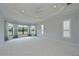 Large main bedroom boasting a tray ceiling, ample natural light, and neutral carpeting at 963 River Wind Cir, Bradenton, FL 34212