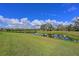 Peaceful water view with lush green grass and large oak trees at 963 River Wind Cir, Bradenton, FL 34212