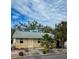 Tan house with palm trees and a gravel driveway at 4706 3Rd W Ave, Bradenton, FL 34209