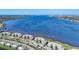 Aerial view of waterfront condo building with parking and lush landscaping at 1010 Tidewater Shores Loop # 103, Bradenton, FL 34208
