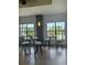 Community room with tables and chairs, offering a bright and airy space at 1010 Tidewater Shores Loop # 103, Bradenton, FL 34208