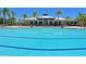 Large community pool with a clubhouse in the background at 1010 Tidewater Shores Loop # 103, Bradenton, FL 34208