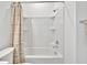 Bathroom with a bathtub, shower, and striped shower curtain at 10358 Abaco Falls Dr, Englewood, FL 34223