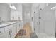 Bathroom with granite countertops, double sinks, and walk-in shower at 10358 Abaco Falls Dr, Englewood, FL 34223