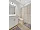 Bright bathroom featuring a white vanity and shower/tub combo at 10358 Abaco Falls Dr, Englewood, FL 34223