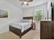 Bedroom with a dark brown dresser and a queen-size bed at 10358 Abaco Falls Dr, Englewood, FL 34223