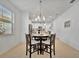 Dining area with round table and chairs, kitchen view at 10358 Abaco Falls Dr, Englewood, FL 34223