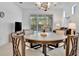 Round dining table with six chairs, view of backyard at 10358 Abaco Falls Dr, Englewood, FL 34223