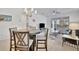 Bright dining area with round table and view into living room at 10358 Abaco Falls Dr, Englewood, FL 34223