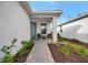 Welcoming front porch with seating area and landscaping at 10358 Abaco Falls Dr, Englewood, FL 34223