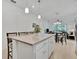 Kitchen island with seating looking into dining and living area at 10358 Abaco Falls Dr, Englewood, FL 34223