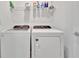 Bright laundry room with washer, dryer, and shelving at 10358 Abaco Falls Dr, Englewood, FL 34223