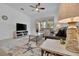 Living room with gray sofa, ceiling fan, and access to patio at 10358 Abaco Falls Dr, Englewood, FL 34223