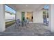 Outdoor patio with seating and view into the living area at 10358 Abaco Falls Dr, Englewood, FL 34223