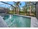 Enjoy the screened-in pool and lush landscaping at 10358 Abaco Falls Dr, Englewood, FL 34223