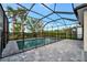 Inviting screened pool with paver deck and tropical views at 10358 Abaco Falls Dr, Englewood, FL 34223