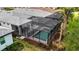 Aerial view of a screened-in pool and surrounding patio at 10358 Abaco Falls Dr, Englewood, FL 34223