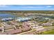 An aerial view of a beautiful community featuring a pool, tennis courts, lakes, and well-maintained landscaping at 10426 Abaco Falls Dr, Englewood, FL 34223
